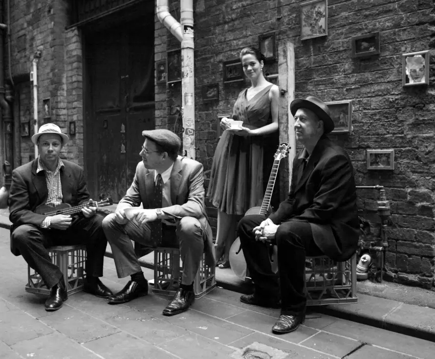The Irwell Street String Band with Hetty Kate, Sam Lemann, Andy Baylor and Leigh Barker posed together in a Melbourne laneway